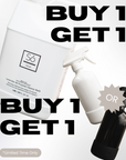 Promotional graphic showing a large white plastic bottle labelled Lavender All Purpose Cleaner, a smaller white spray bottle, and a black spray bottle with large overlaid text reading 'BUY 1 GET 1' and a gray 'OR' badge on a light background.