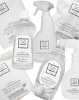 A set of Só Clean laundry and bathroom cleaning products on a white background, including clear bottles of Citrus Rinse Aid and Tangerine Dish Soap, white bottles of Lavender All Purpose Cleaner and Stain Remover and Prewash and white bags of powdered laundry soda, citrus dish capsules and oxygen whitening powder.