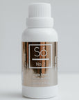 White bottle with a gold label labeled Só No. 2 Jingle Smells Toilet Drops on a white background