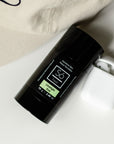 Black deodorant stick with 'Só Fresh Sensitive Skin Limelight" branding on a light background with apple air pods and a beige hat