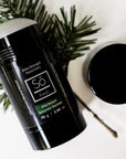 Black deodorant stick with 'Só Fresh Extra Strength Wild Balsam' branding on a white background with greenery.