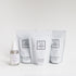 Four Só products arranged on a clean white studio background. The products include Coconut & Oat Milk Bath Soak, Blush Soak, Coco Cream Soak all in white resealable pouches with black labeling and a small clear spray bottle with a white label of Magnesium Oil.