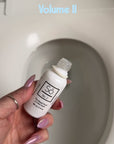 Video showing a hand holding a bottle of Só No. 3 Toilet Drops The Royal Flush over toilet bowl dropping product into the toilet with text overlay on the photo that says "Volume II - Is it Magic or is it Só" and "Makes No. 2s smell like Number Who?"
